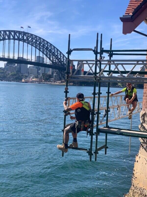 Cantilevered scaffold supported from the structure above open water