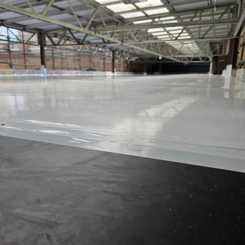 Roof-level shrink wrap encapsulation on an industrial building near Central Station