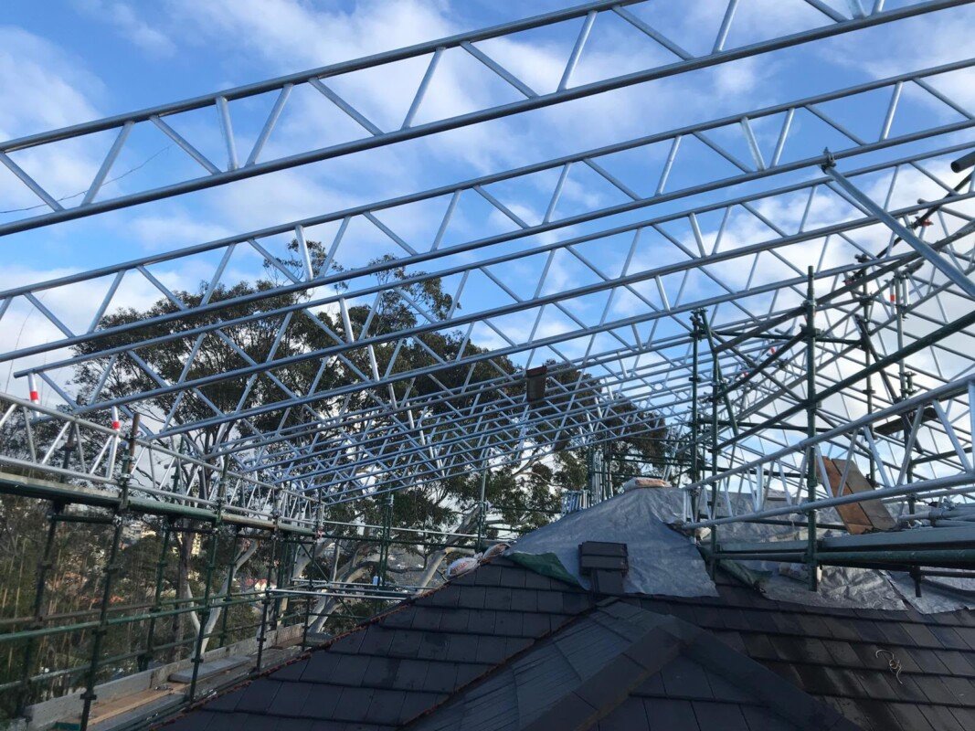 Temporary roof system installation in progress on a residential site